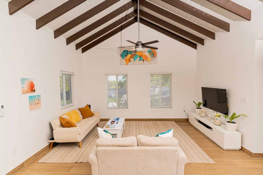 Spacious luxury living room with vaulted ceiling and comfortable seating at Blue Water Villa in Grand Turk.