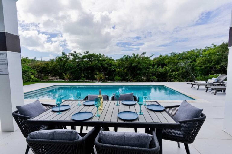 Outdoor dining area overlooking the private pool, perfect for meals and entertaining.