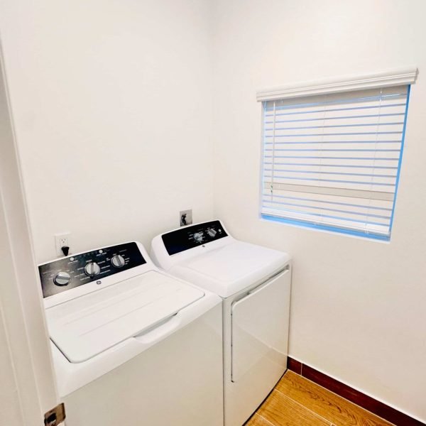 Convenient in-villa laundry room with washer, dryer, and storage space at Blue Water Villa in Grand Turk.